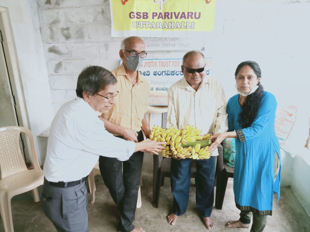 Distribution of N 95 masks, Sanitary pads, sanitizer and fruits to physically disy at Jnana Jyothi Kendra